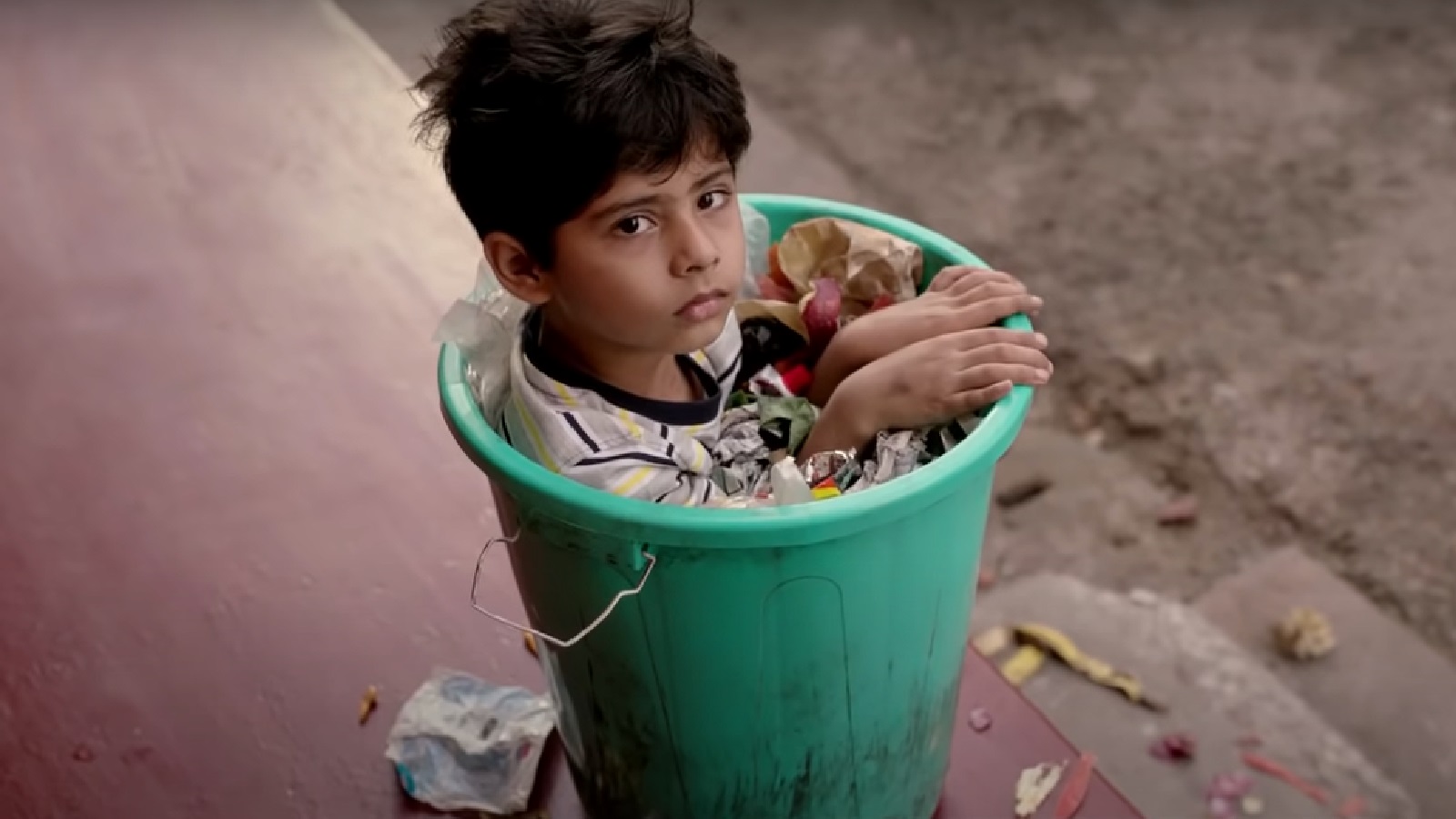 Boy Gets “Stuck” in a Trash Bin to Make a Point About Waste Management